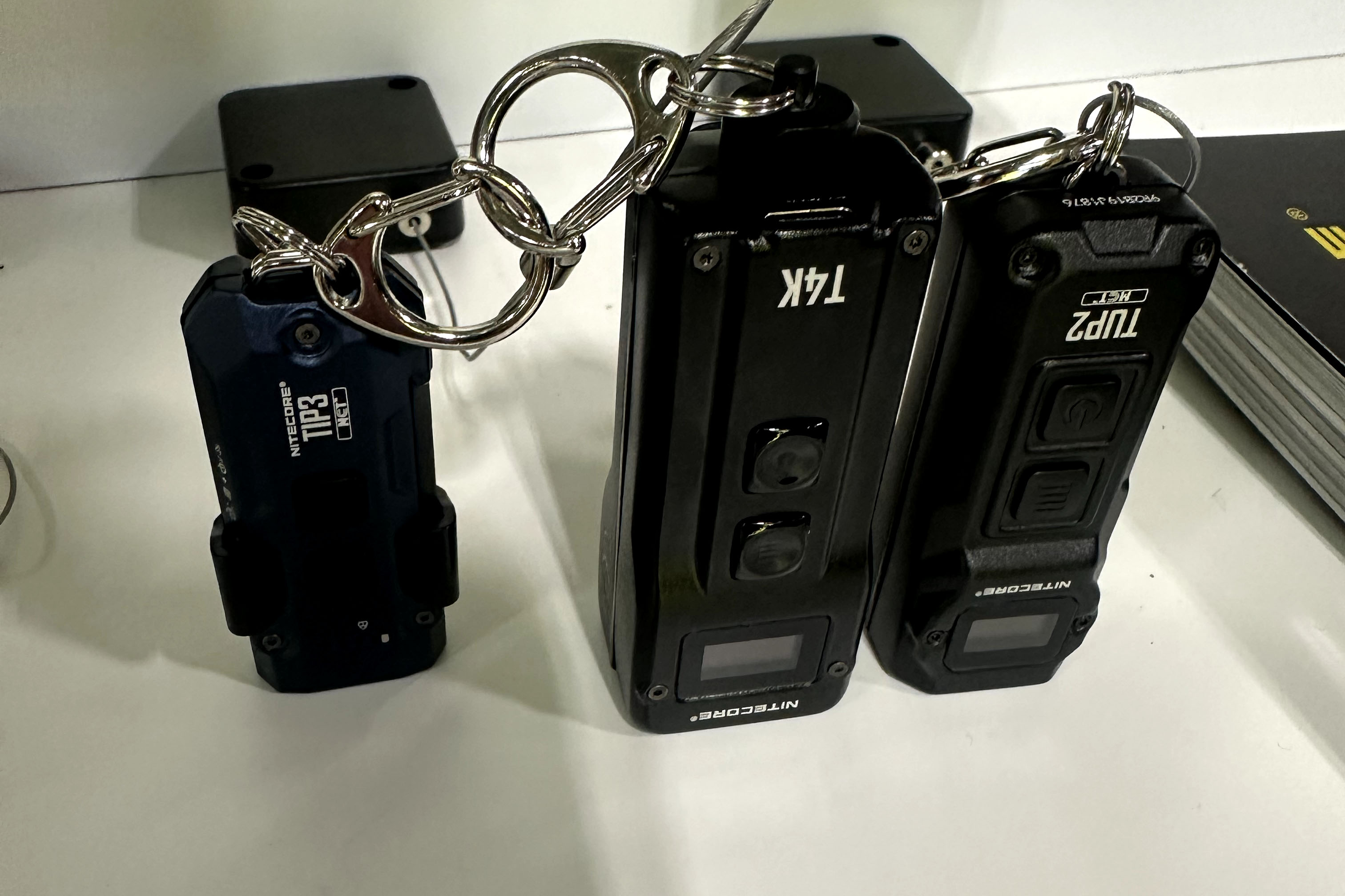 The Nitecore Tip 3 next to other small flashlights at SHOT Show 2026