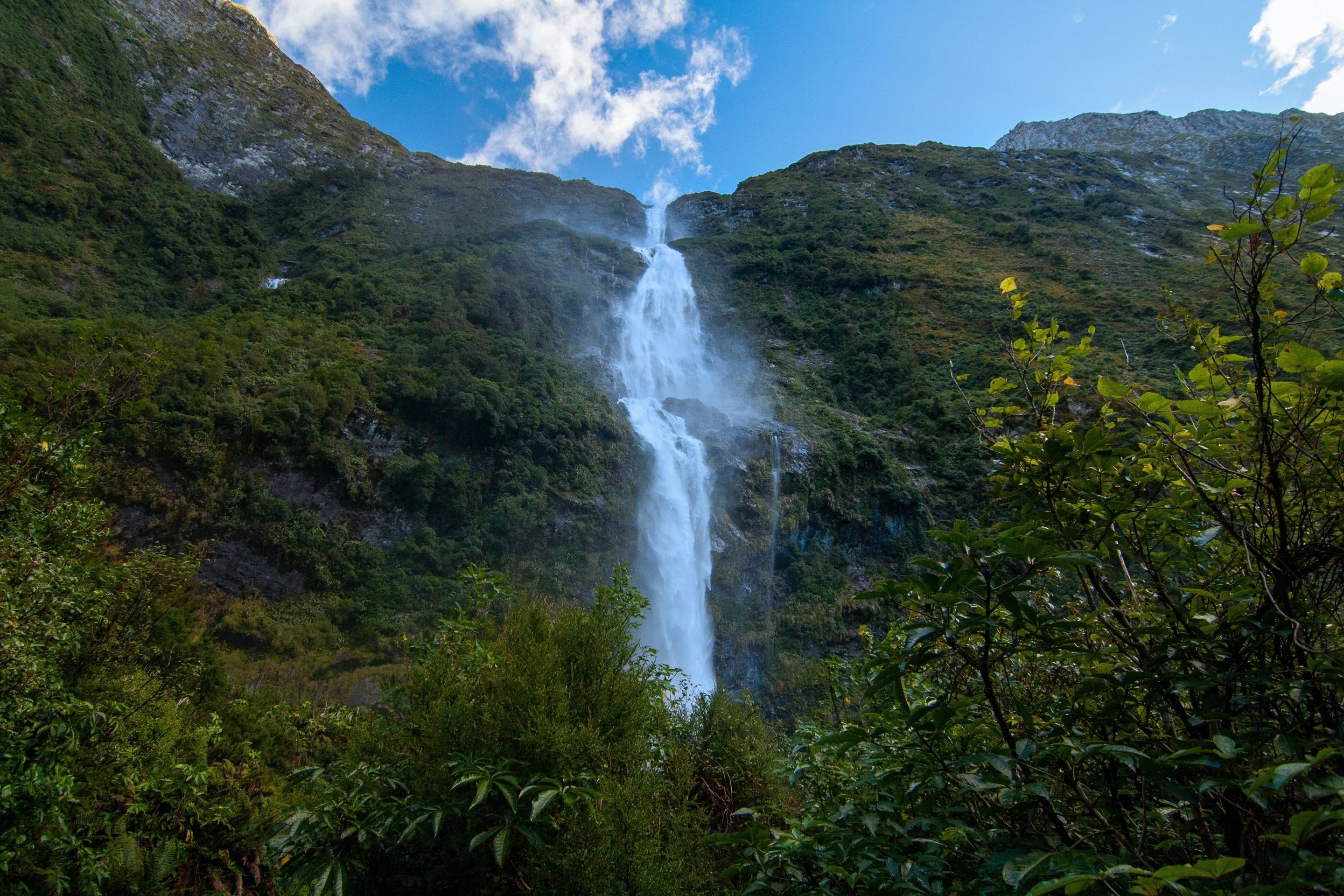waterfall surrounded by green mountains