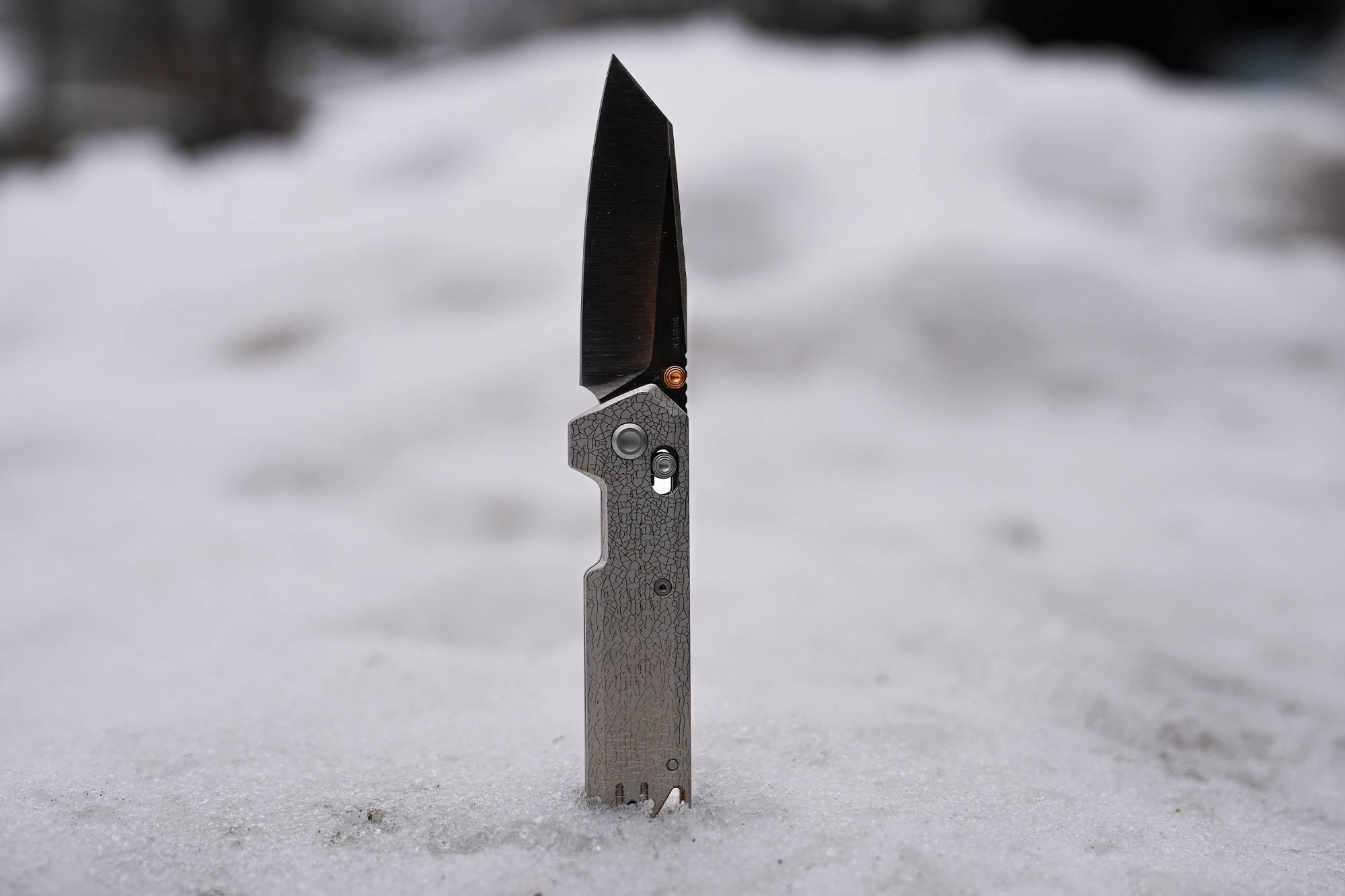 The Vosteed Parallel knife shown open and standing upright in packed snow
