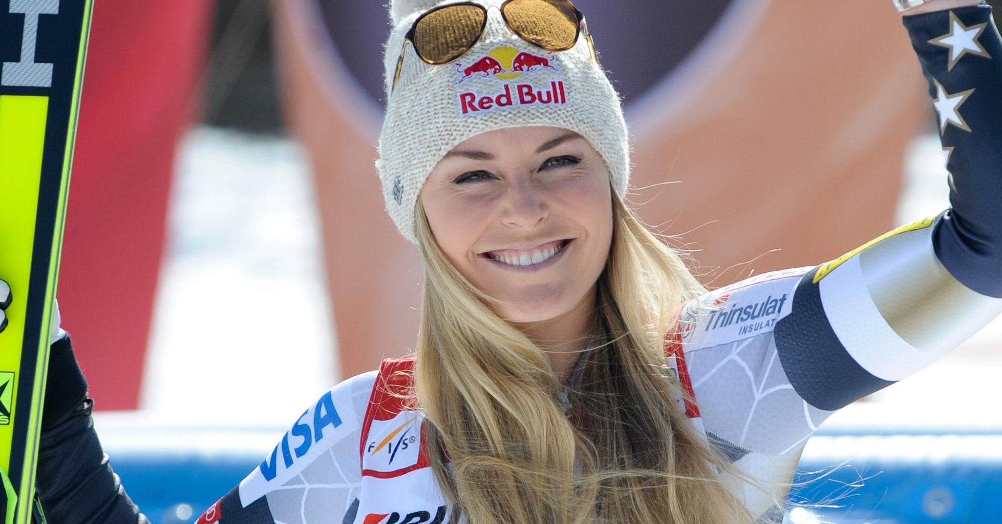 Lindsey Vonn in beanie and sunglasses waving to crowd