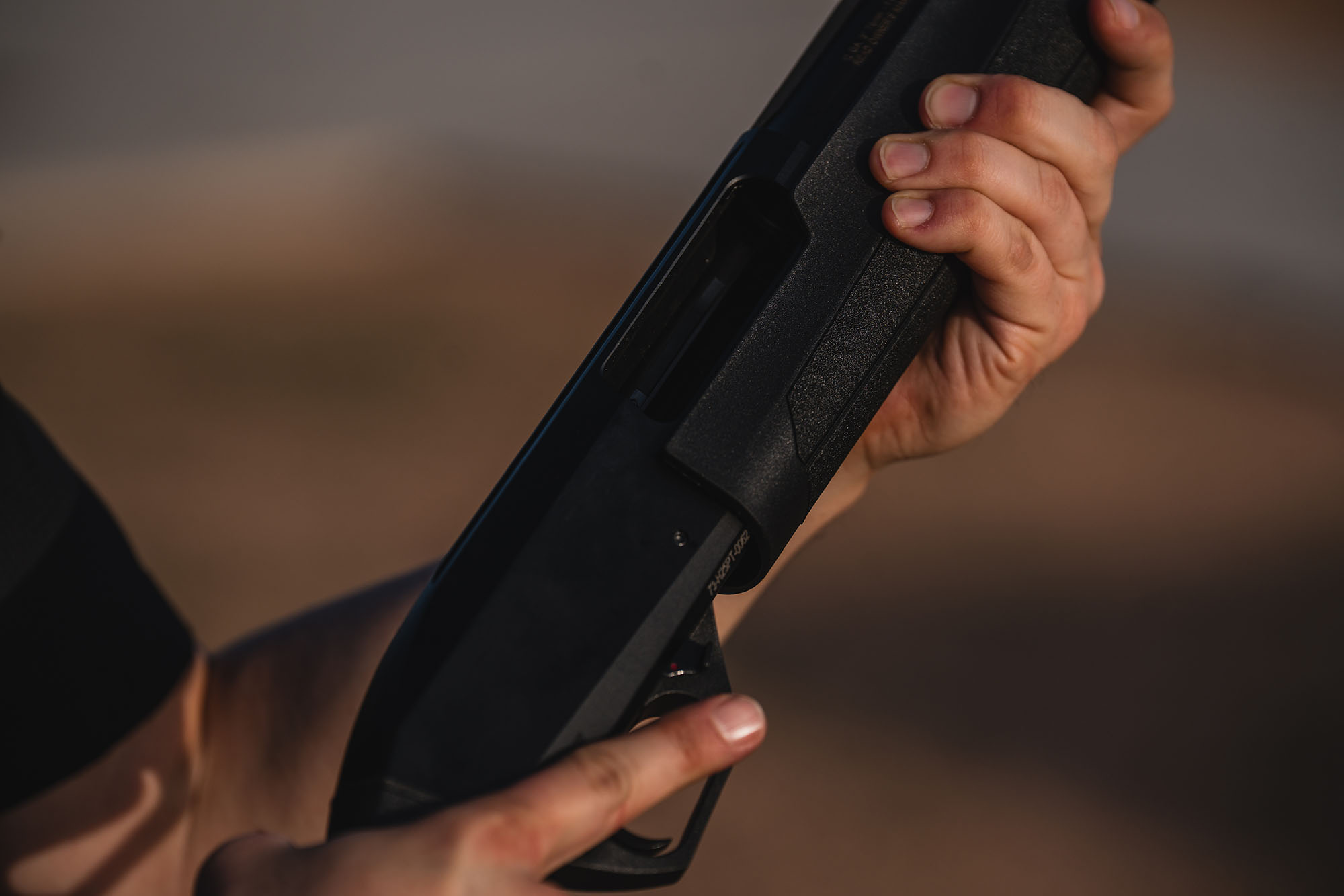 Man holding Redfield Shotgun