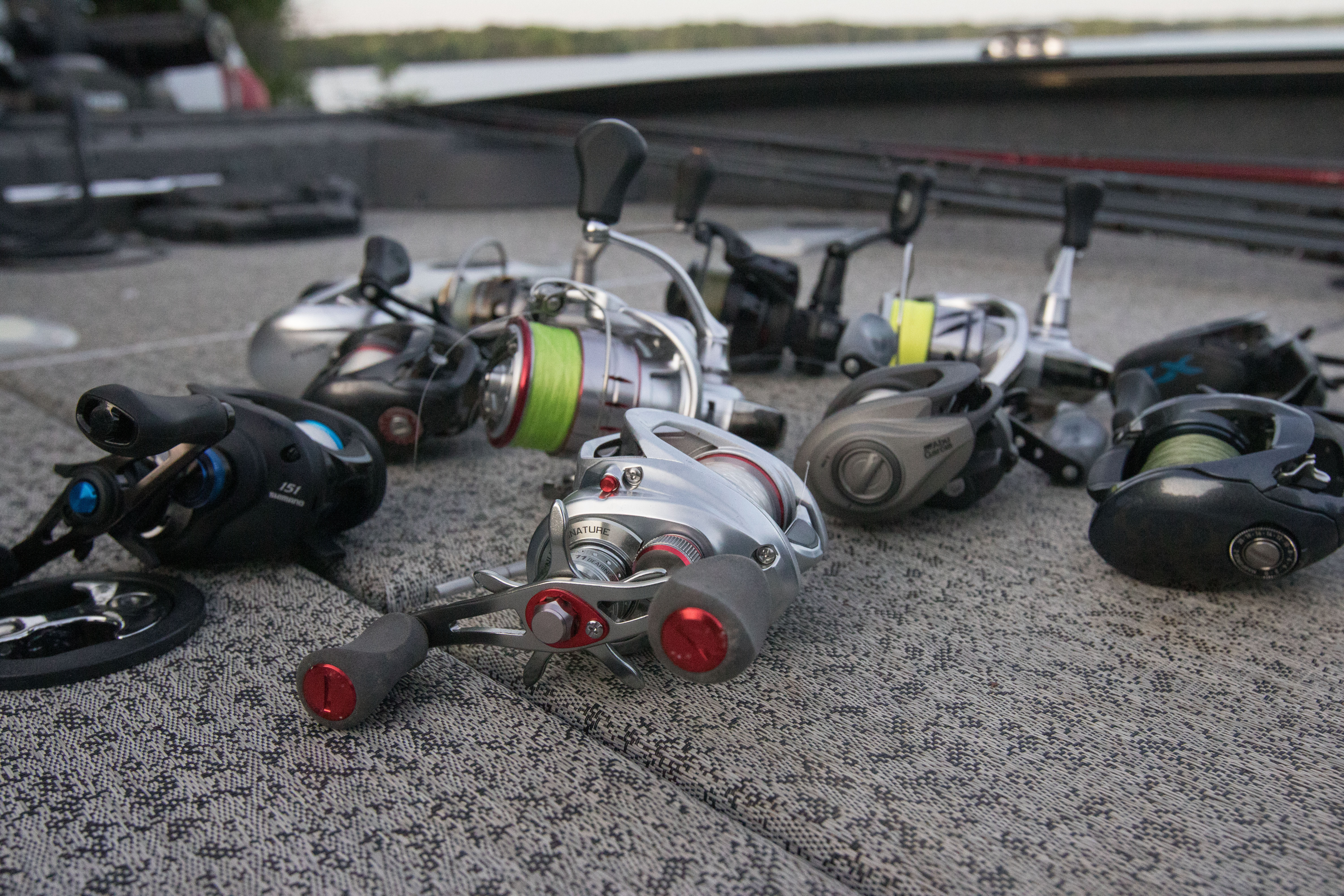 The best bass fishing reels on a boat deck by a lake