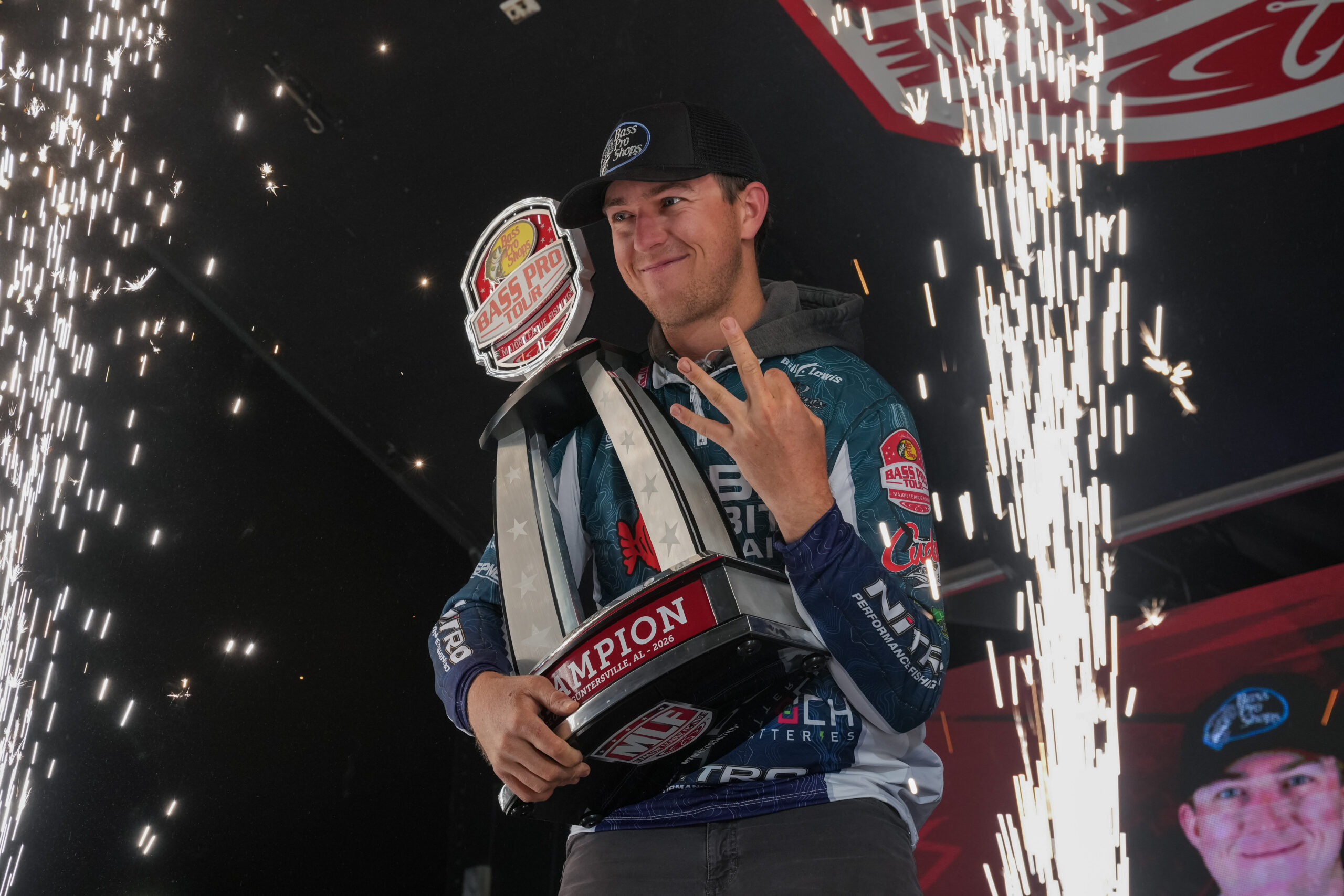 Drew Gill hoisting a trophy from MLF Stage One amid fireworks.