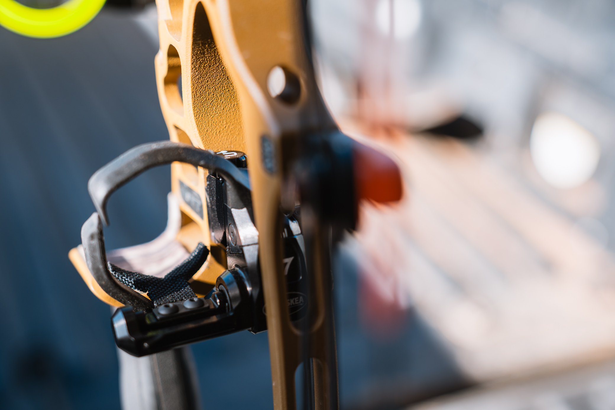 A close-up shows the arrow rest launcher and cord system mounted on the bow riser