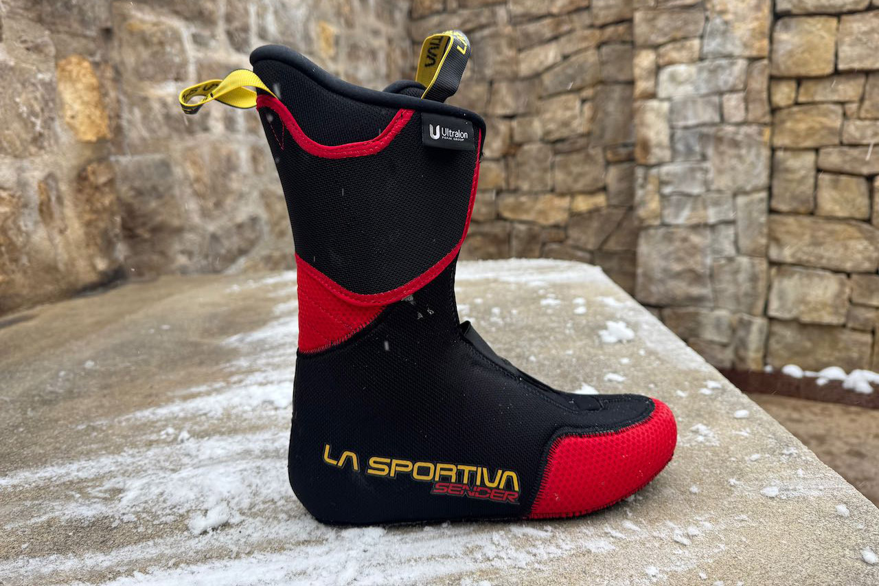 The La Sportiva Sender liner is shown outside the shell, highlighting its shape and pull tabs
