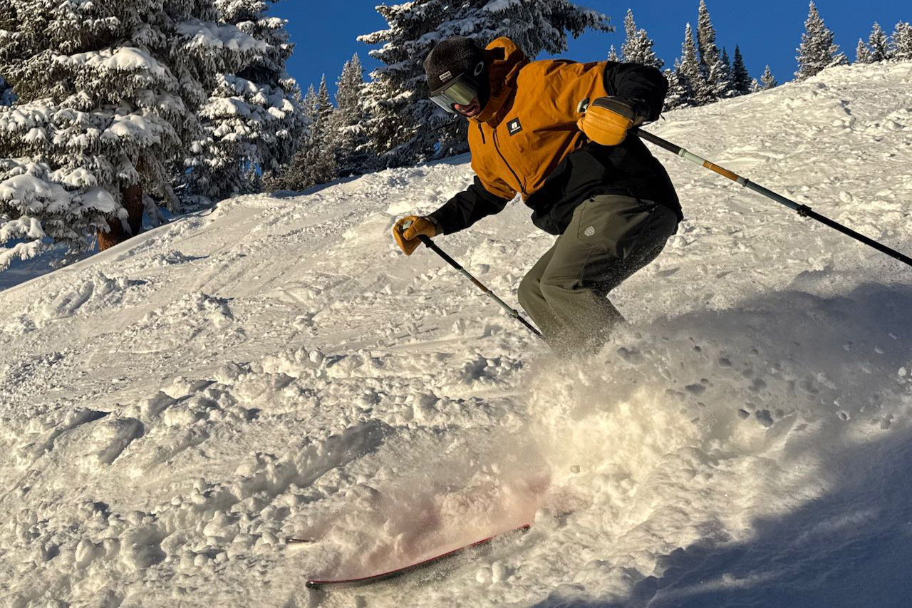 La Sportiva Sender boots are worn while skiing through soft powder snow in sunny conditions