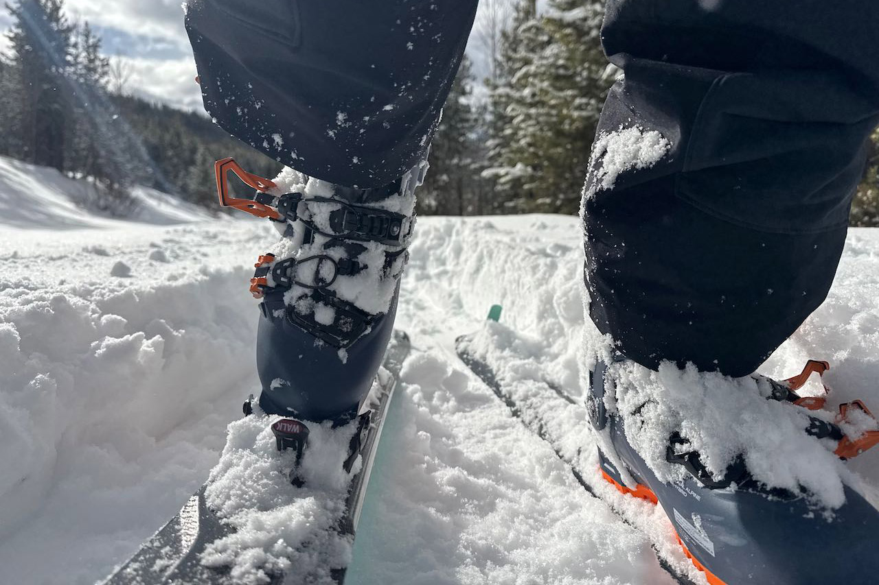 Rear view of Scarpa 4-Quattro GT boot walking uphill in snow