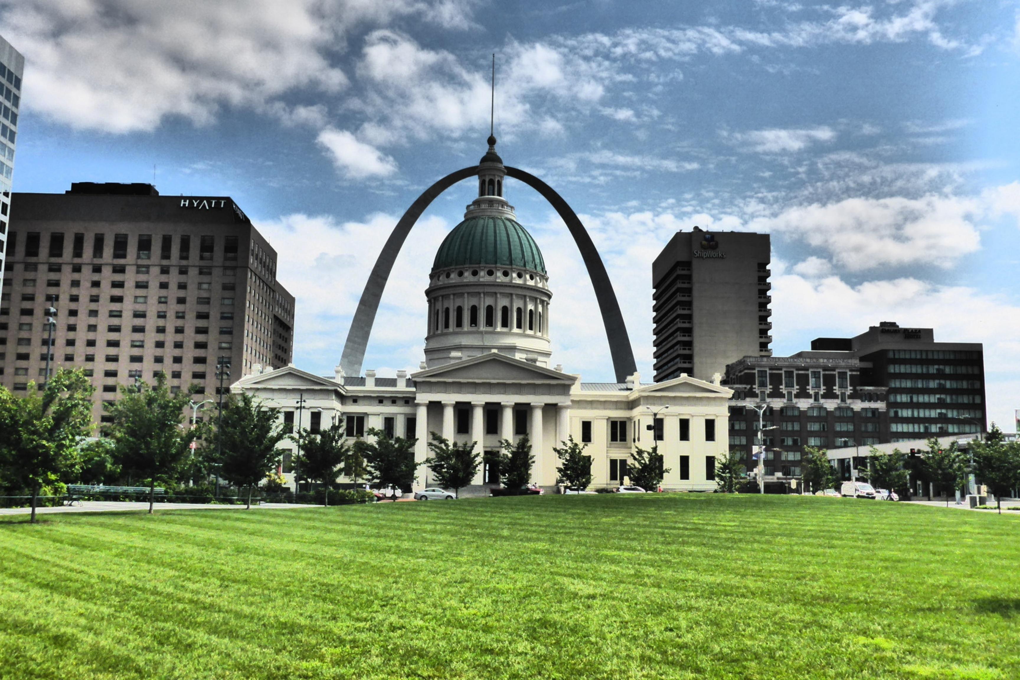 old courthouse with arch in background