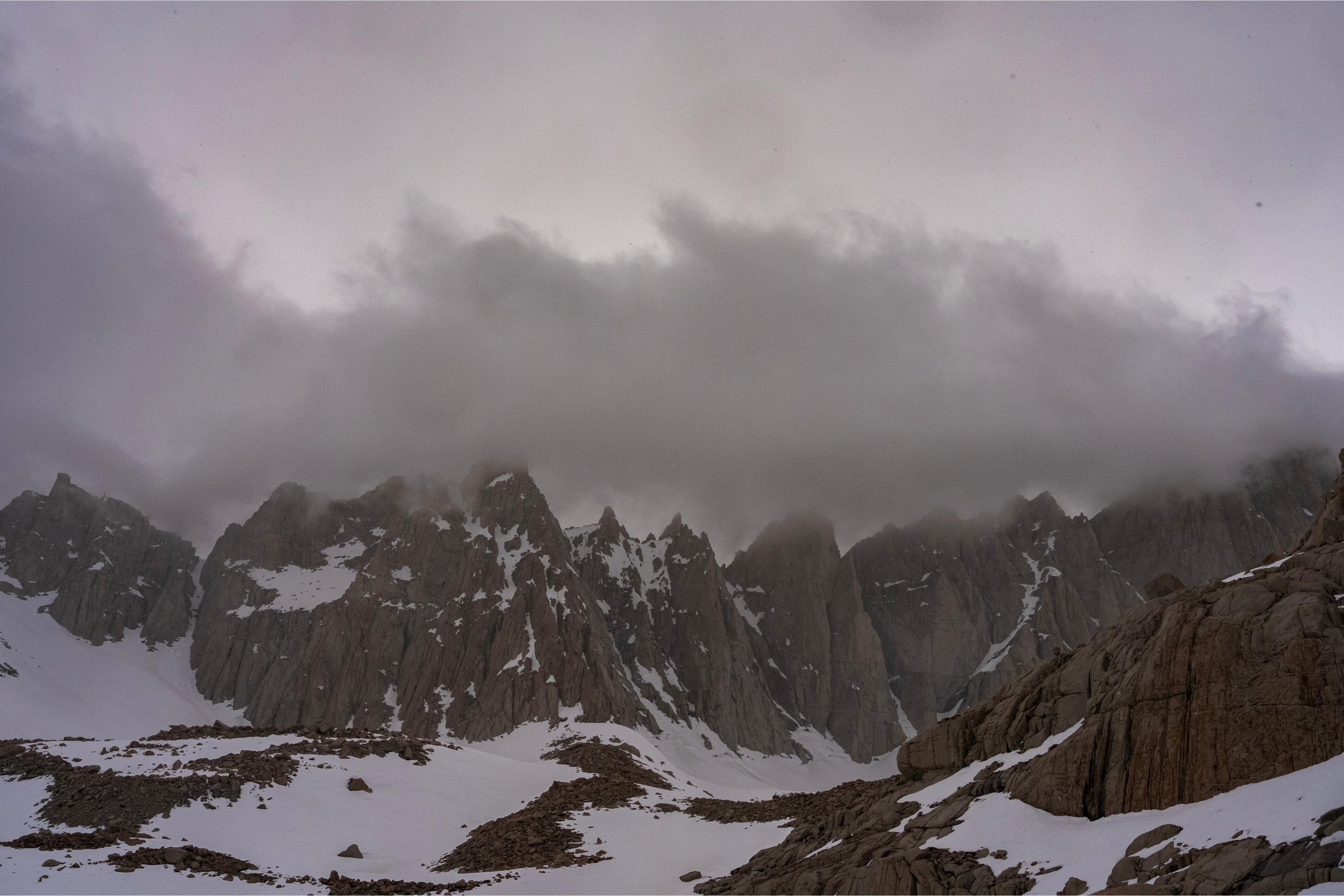 snowy mountains with clouds