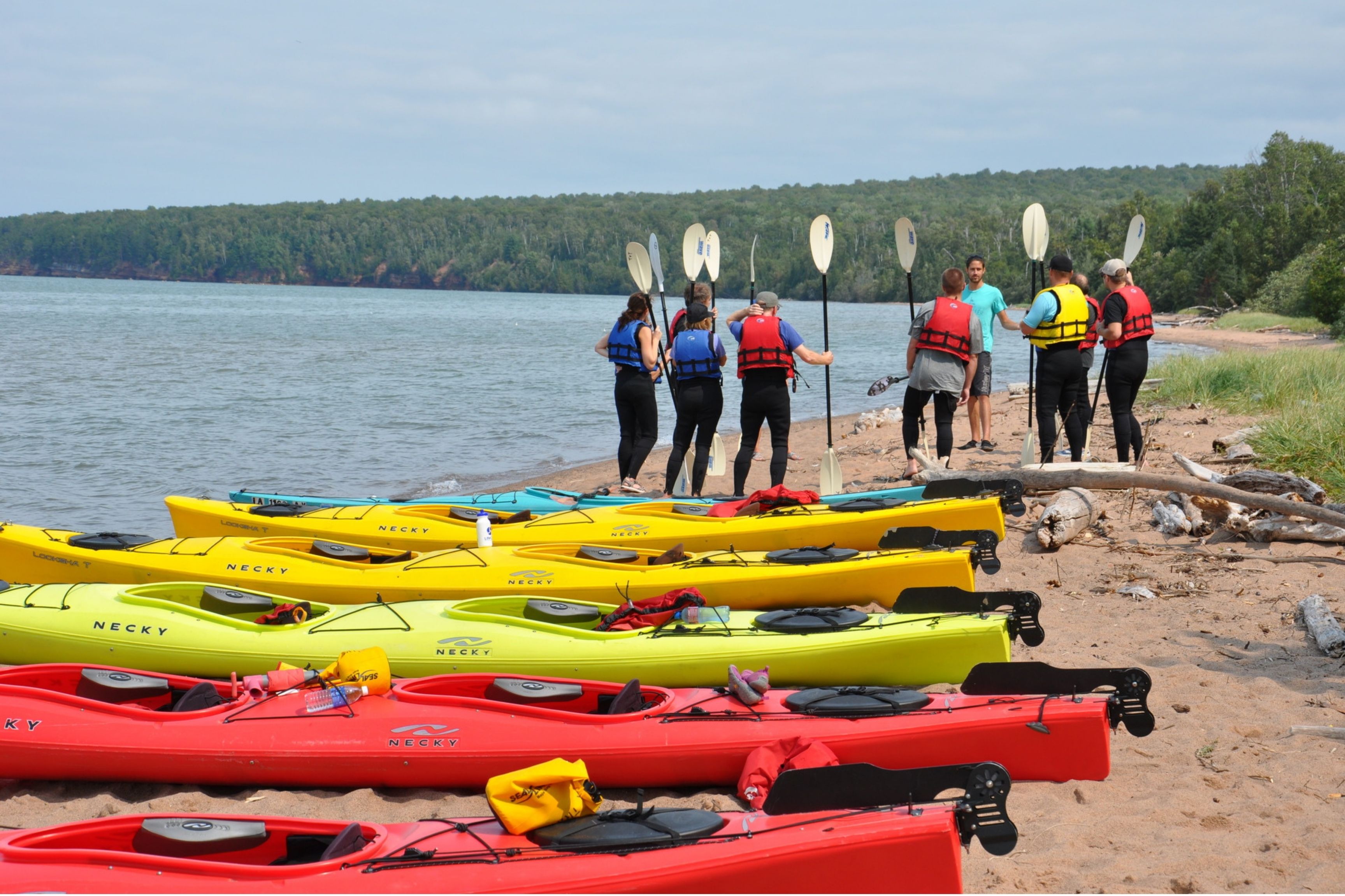 group of kayakers on beach