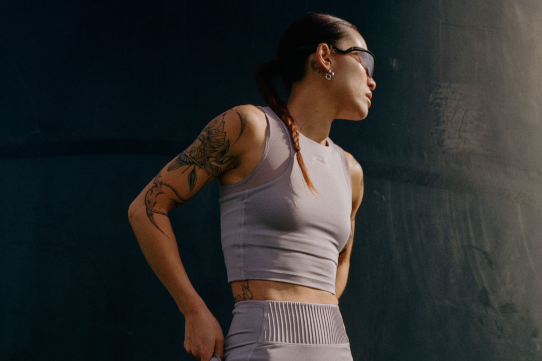 runner stands in lilac shorts and crop top