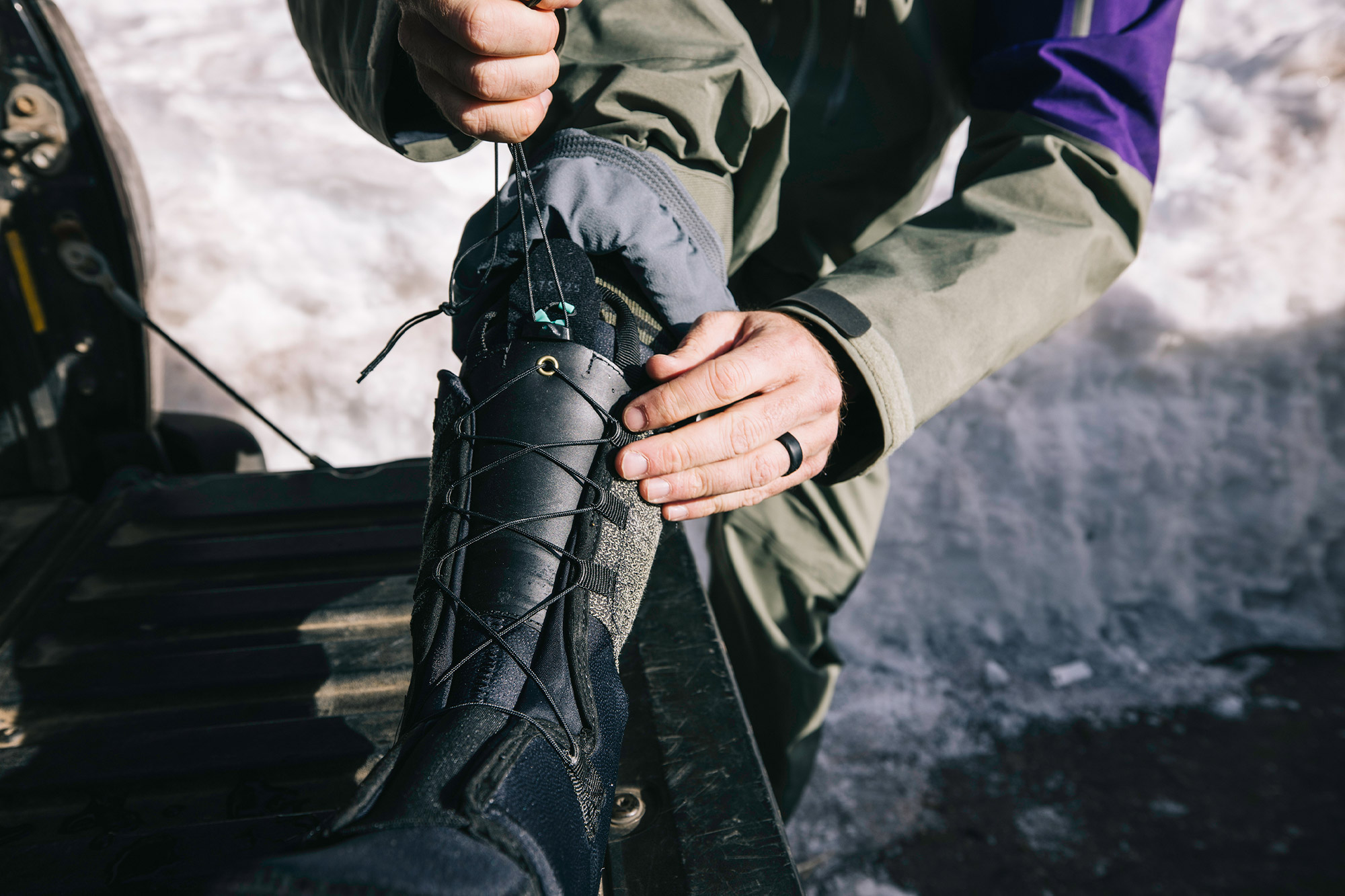 Hands tightening the lace system on a Zipfit liner during setup