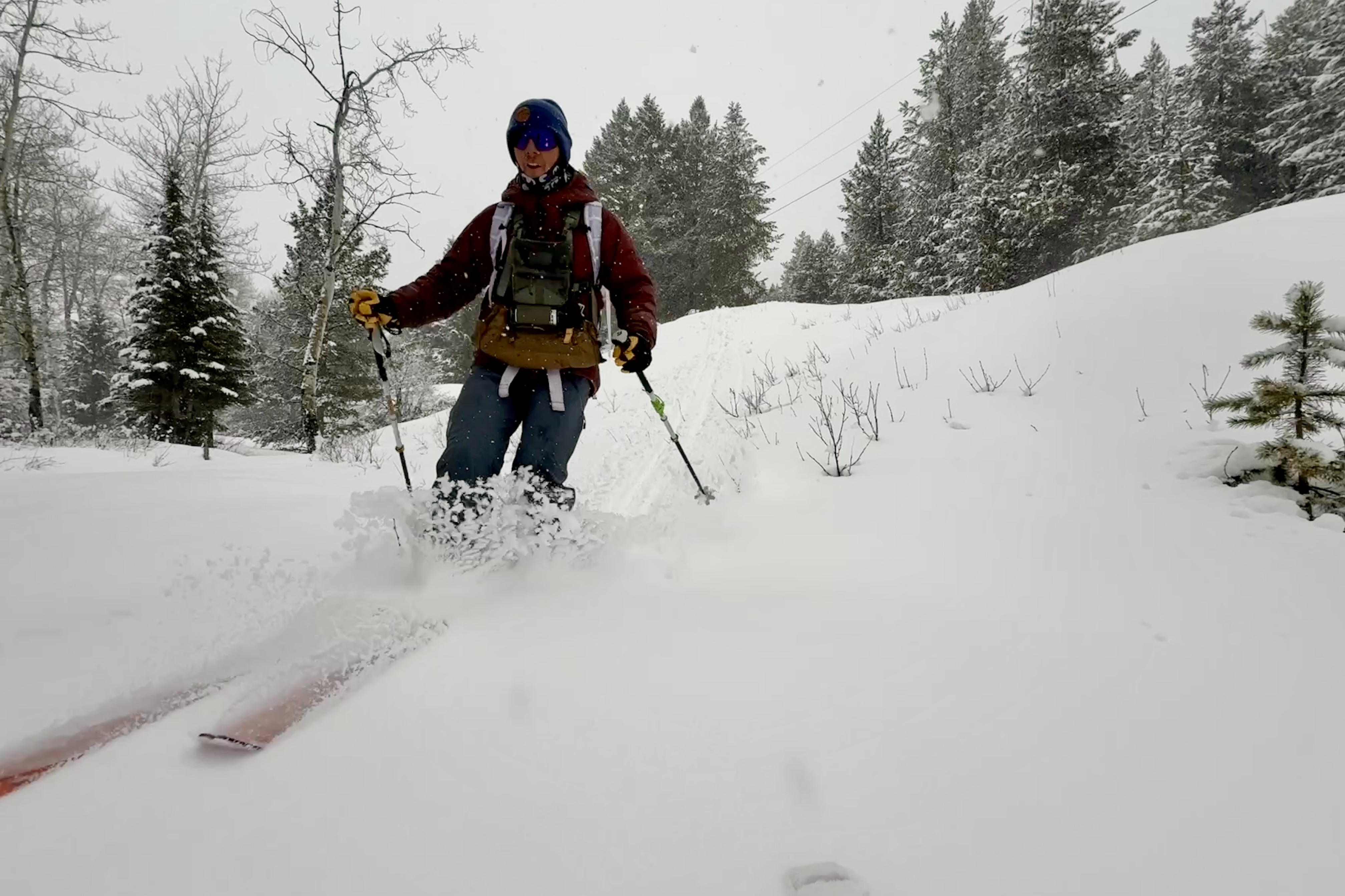A skier skiing downhill in the snow using the Rossignol XP 105 Positrack skis