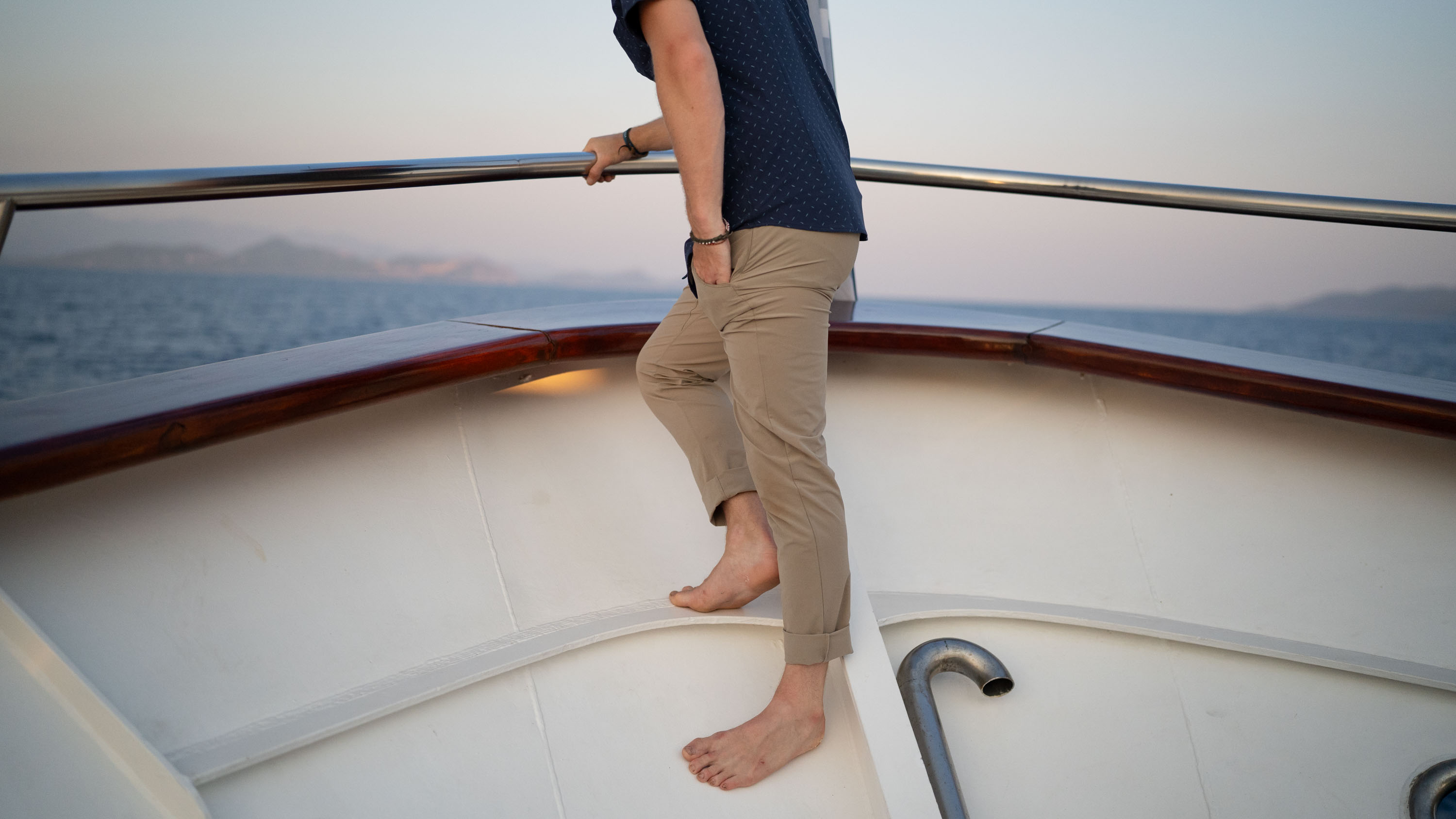 a gearjunkie tester wearing travel pants on the deck of a ship