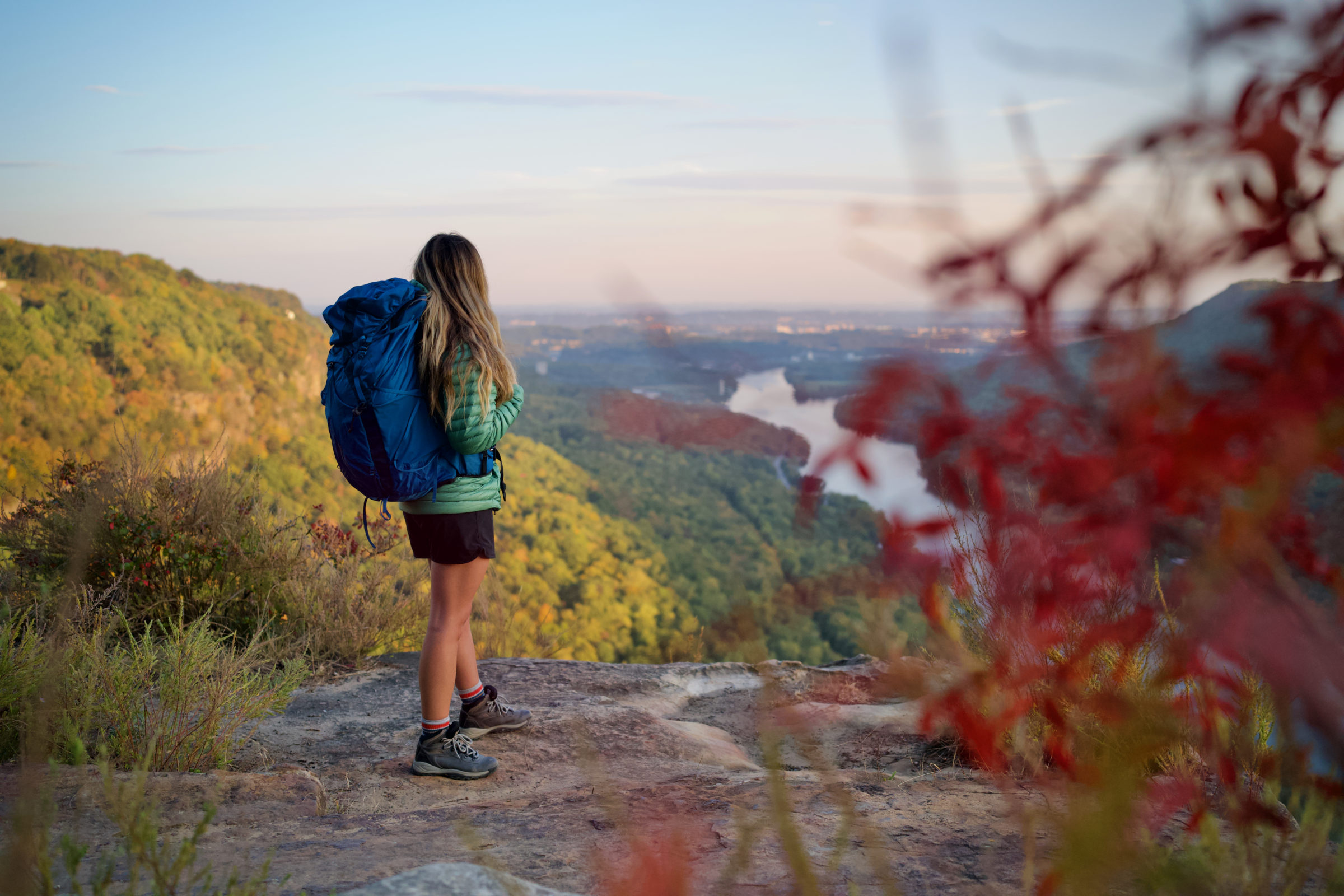 a backpacker wearing the osprey exos 58 overlooks a view in the southeast