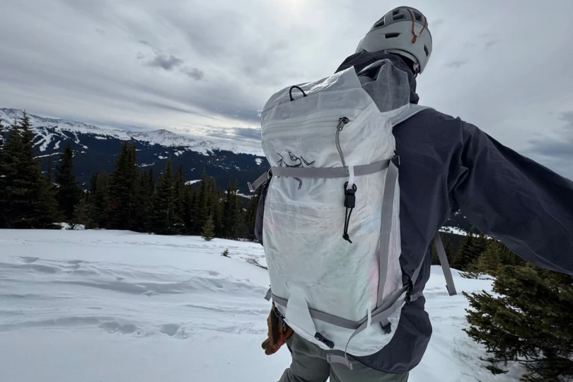 The Arc’teryx Alpha SL backpack worn while touring above a mountain valley