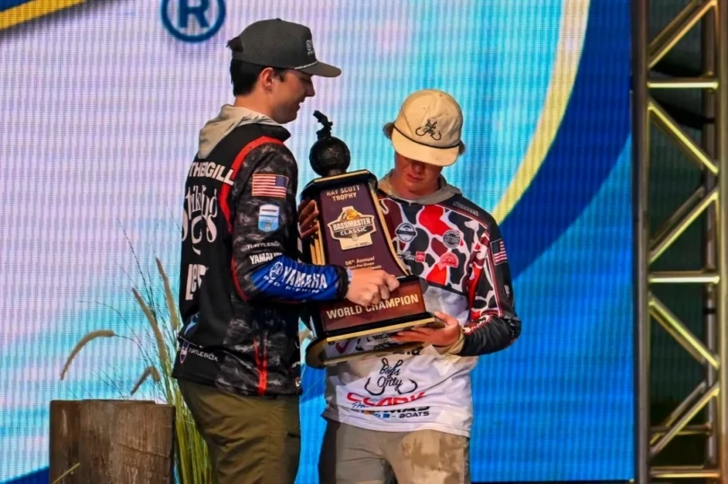 Easton Fothergill handing Dylan Nutt a trophy.