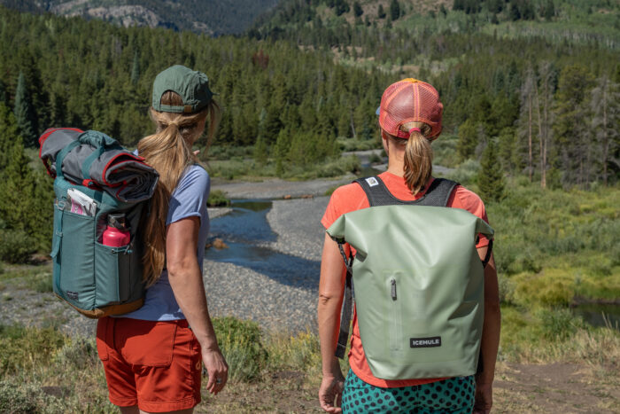 two women looking out across river bend 