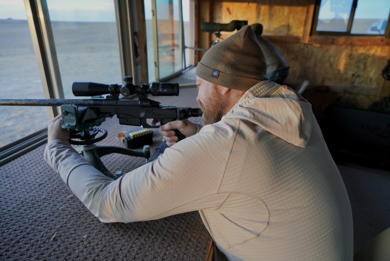 Someone shooting at a shooting range while wearing the Kifuru Roam Crosslayer Hoody