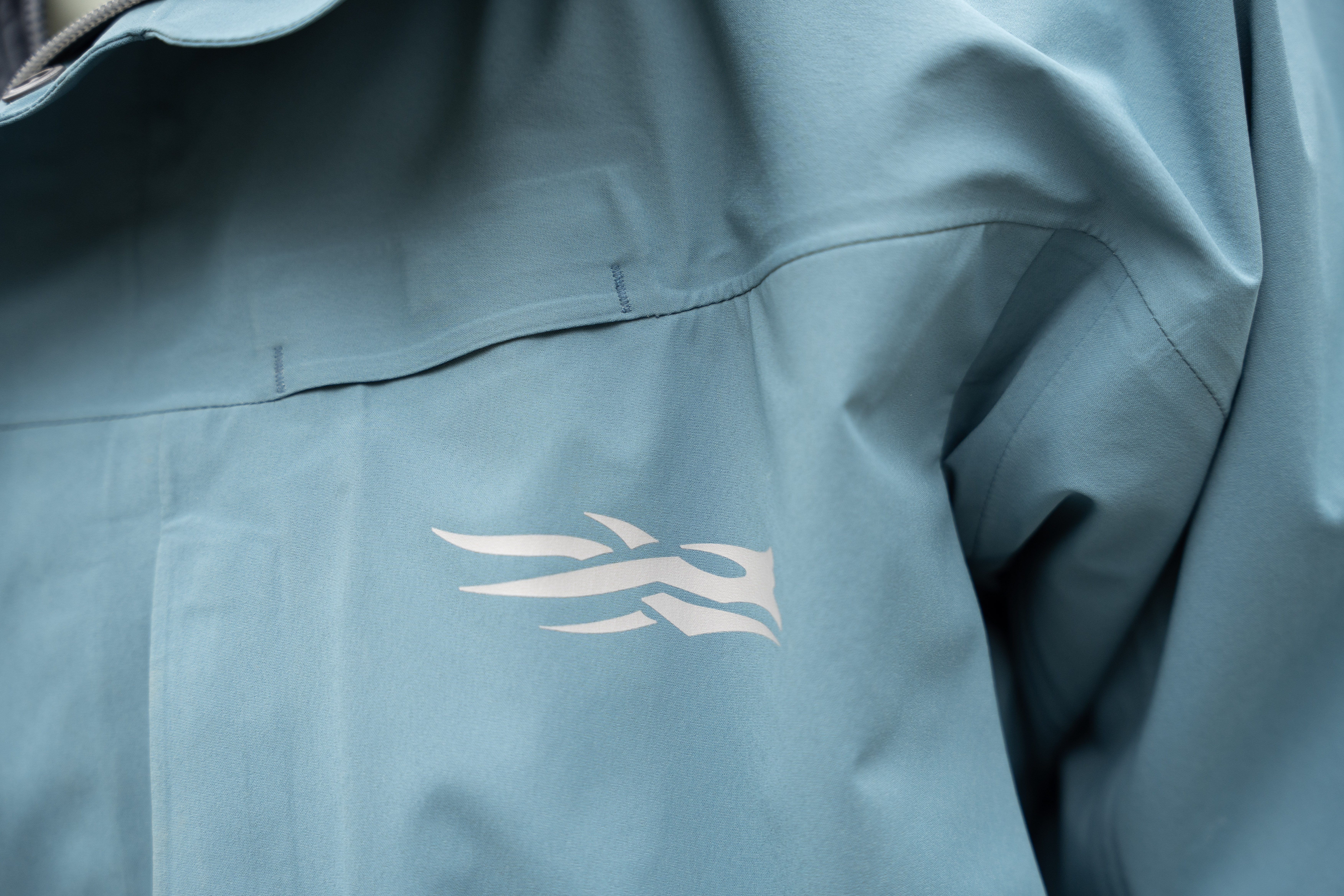 A closeup image of a rain jacket logo.