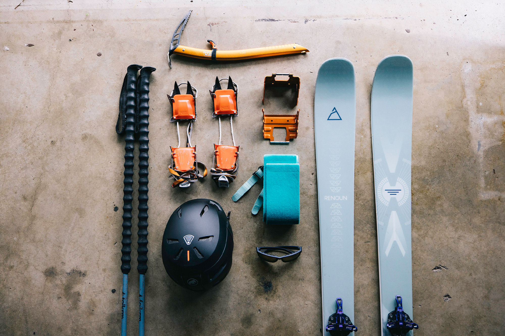 Spring volcano skiing setup with skis skins helmet and climbing gear