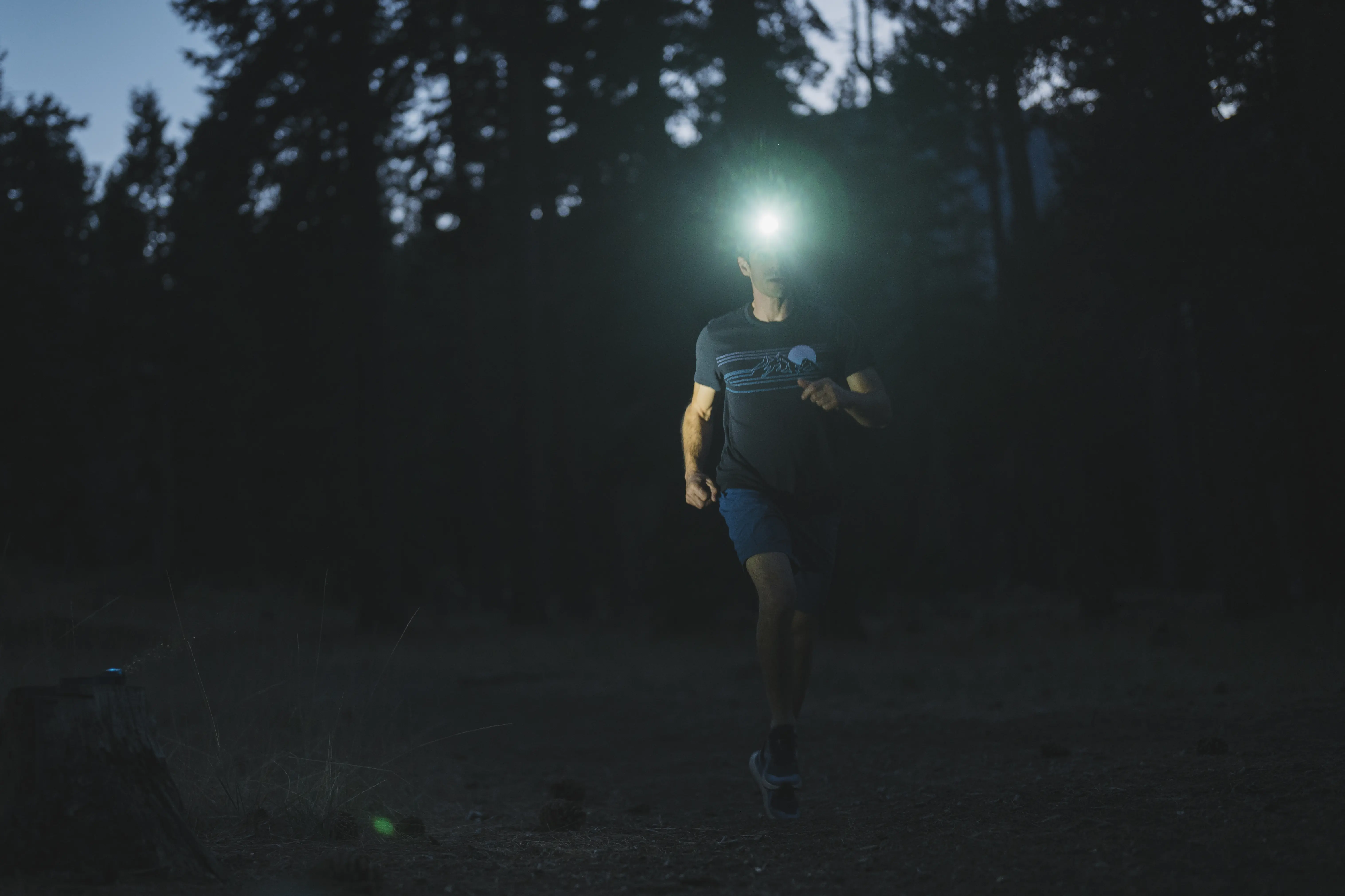 Man running while wearing a headlamp