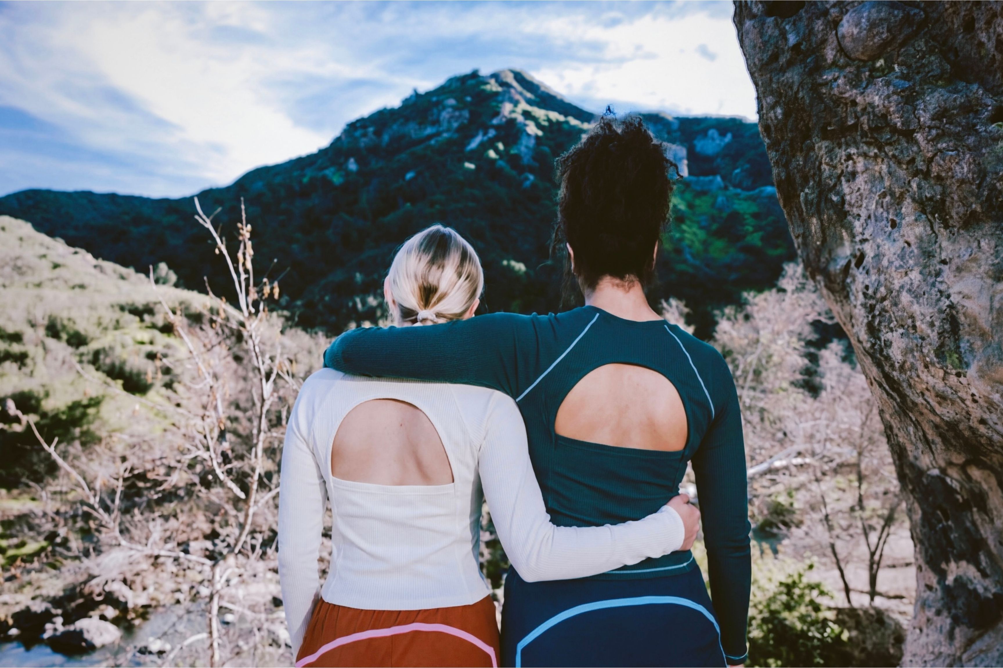 view of two women from behind hiking