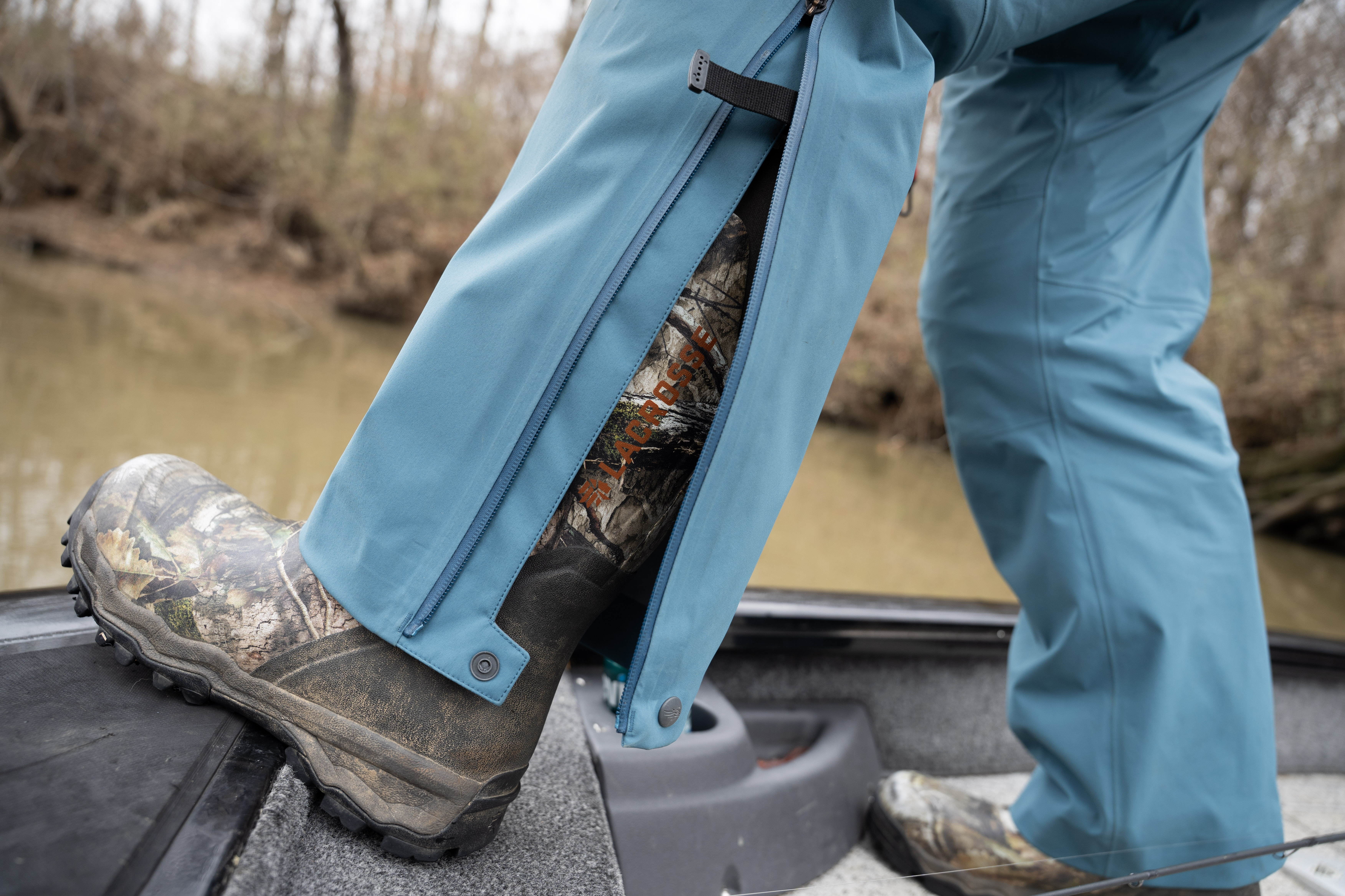 The leg of the SITKA CAT 5 bib unzipped around a rubber boot.