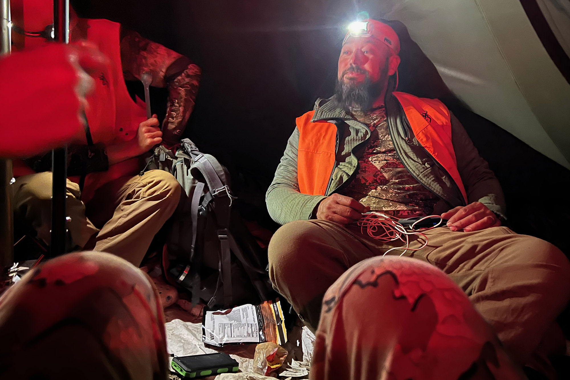 Hunter in a tent with a headlamp