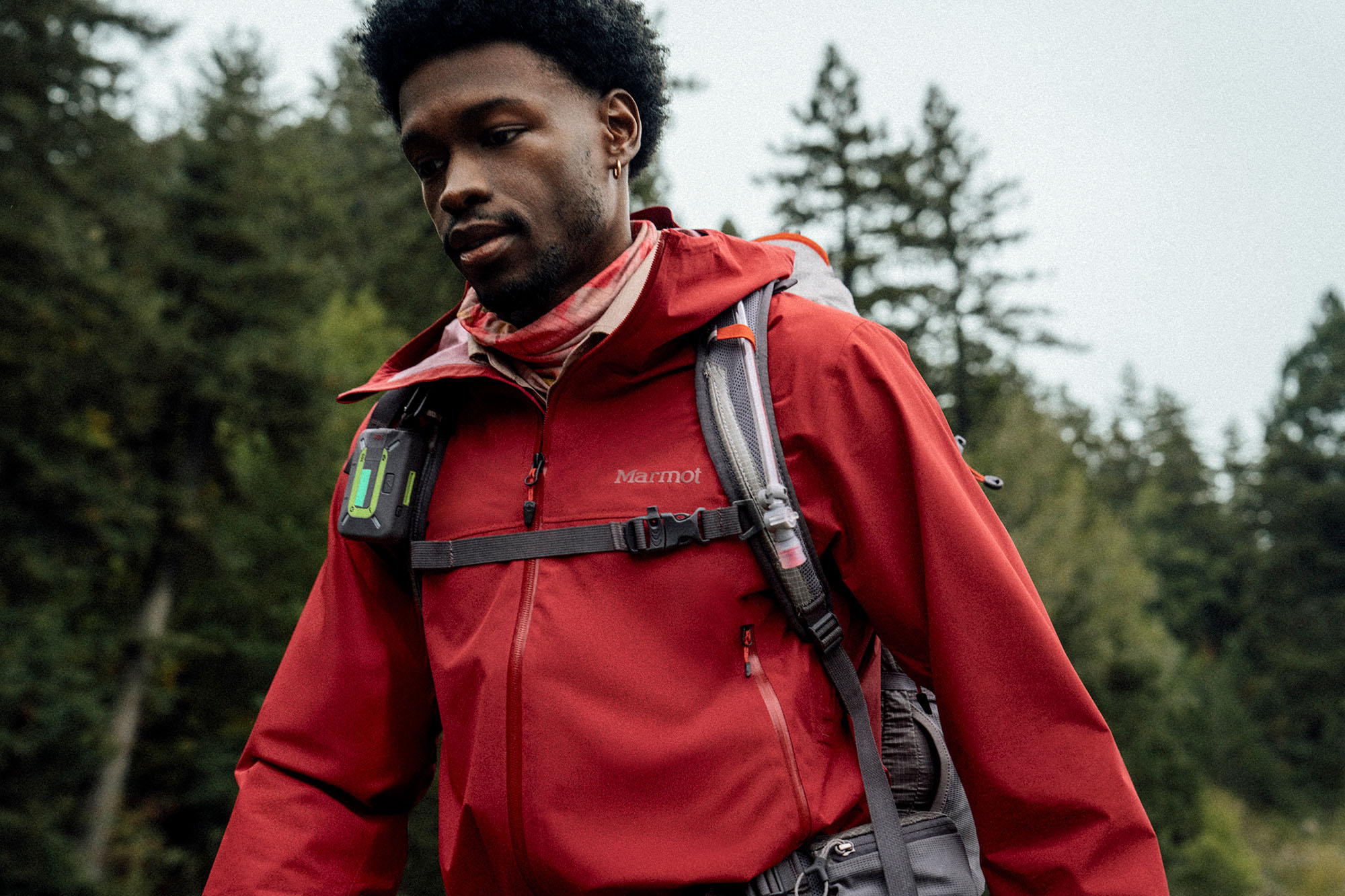 man hiking in marmot rain shell