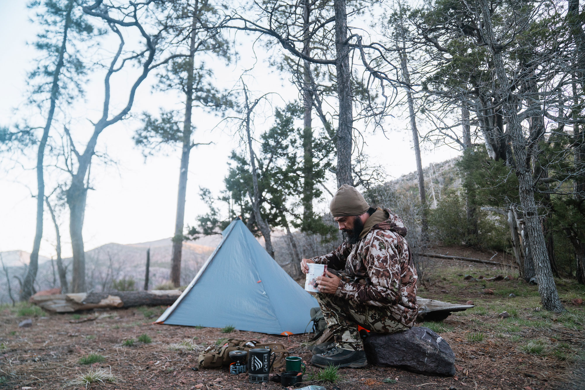 a man in a hunting tent
