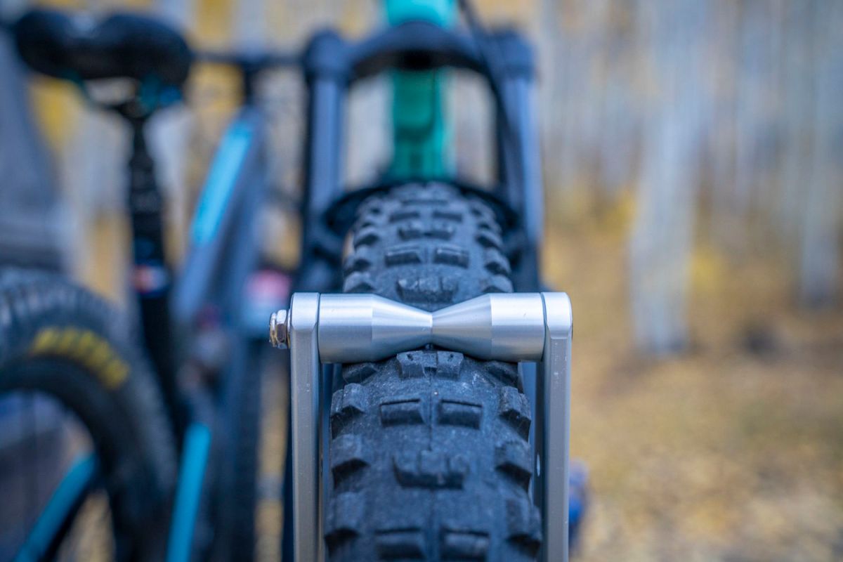 Front view of a bike tire secured between the 1Up rack’s metal rollers