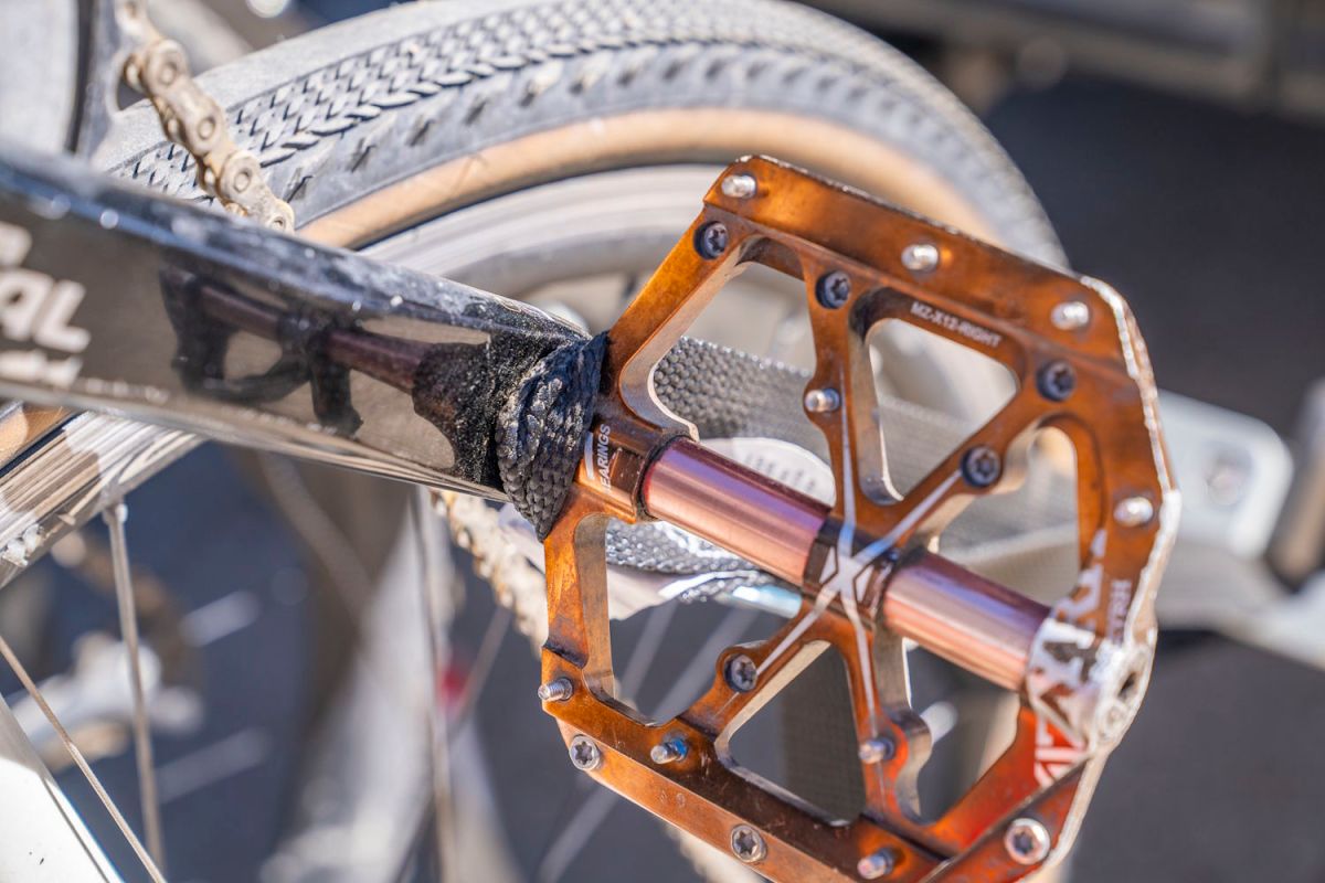 Cinch strap looped around the pedal to secure the bike on the 1Up Recon rack.