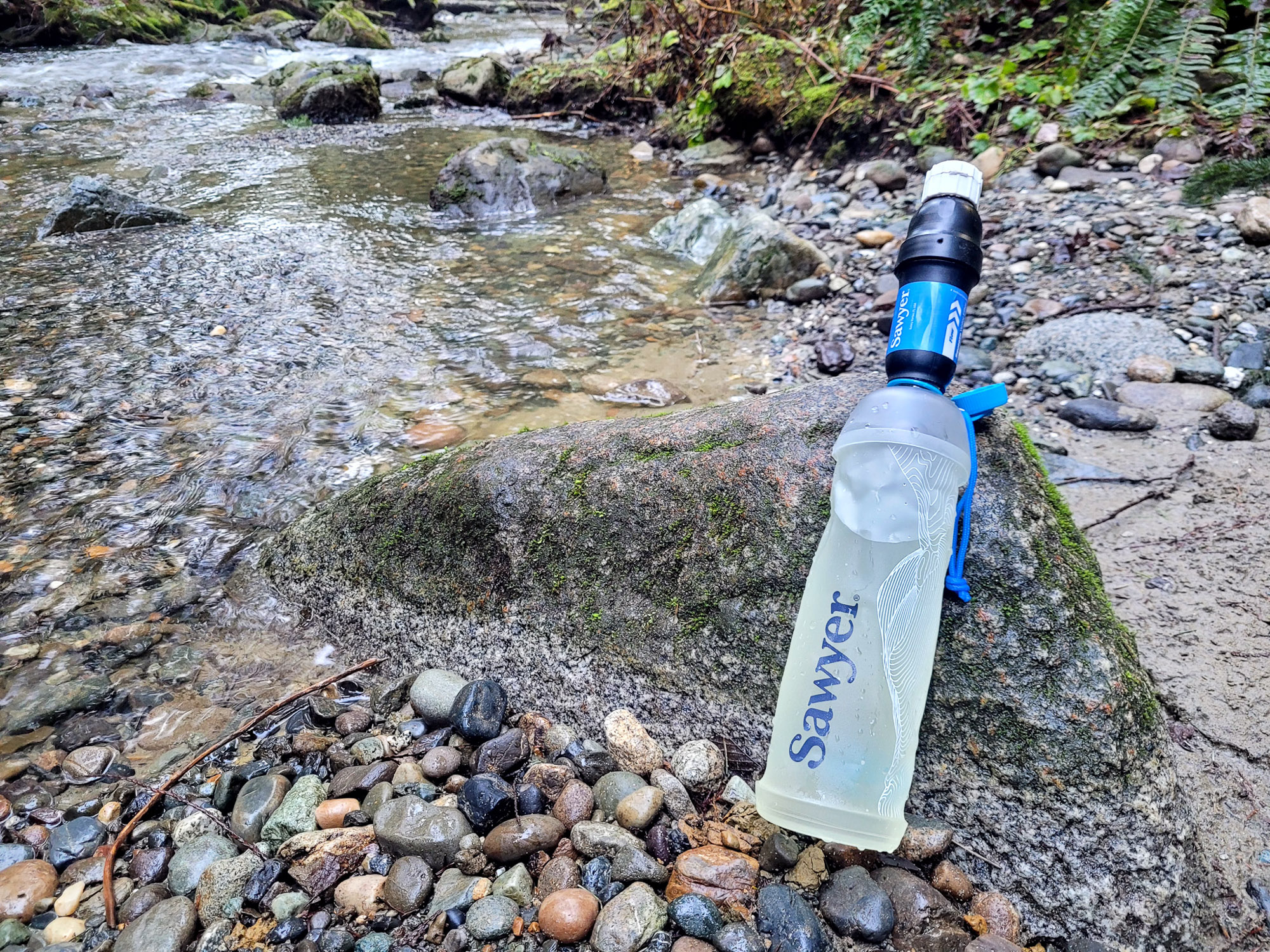the 1-liter cnoc bladder and filter combo on a creekside in washington state