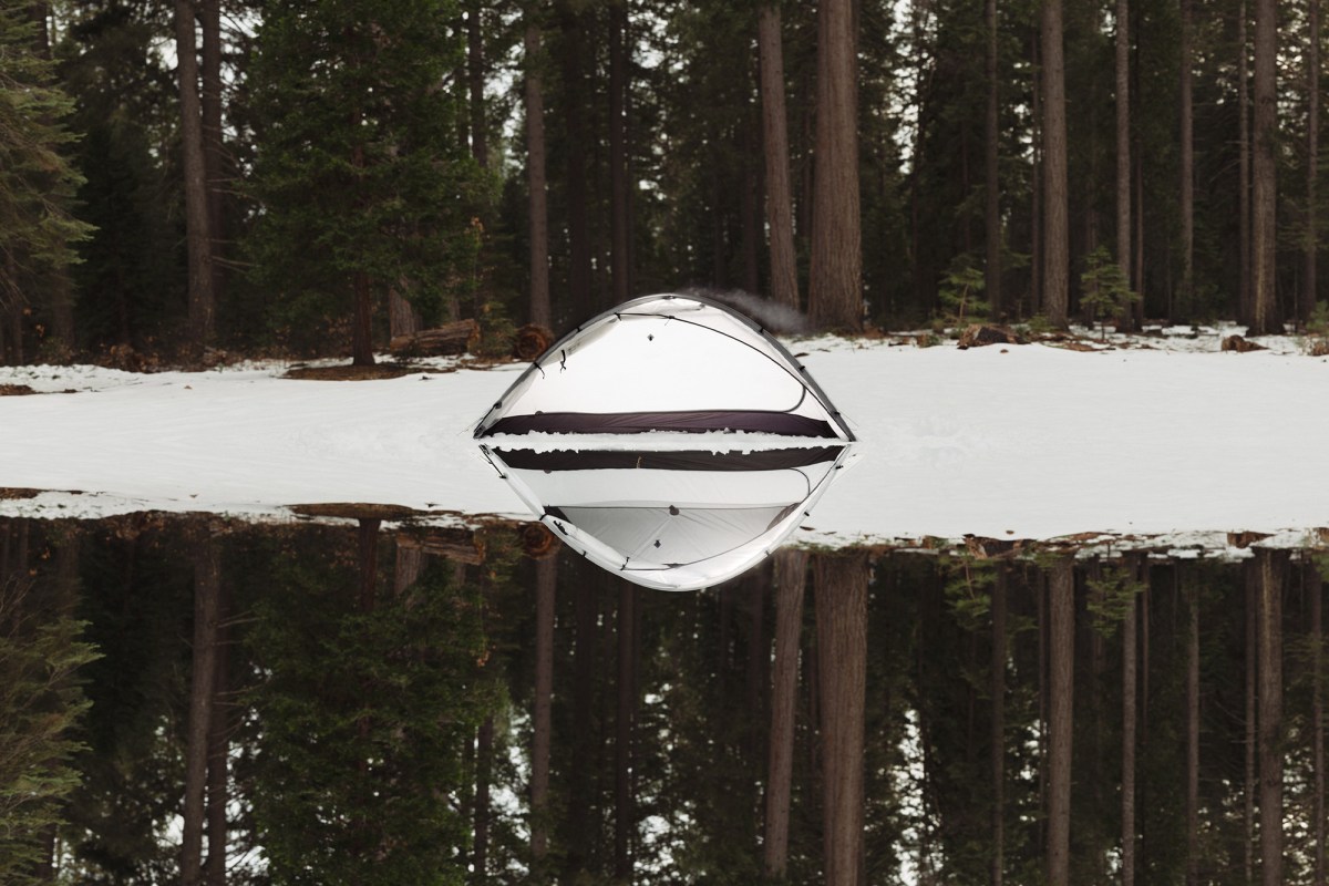 ArcDome 1 tent reflected in still water with forest background