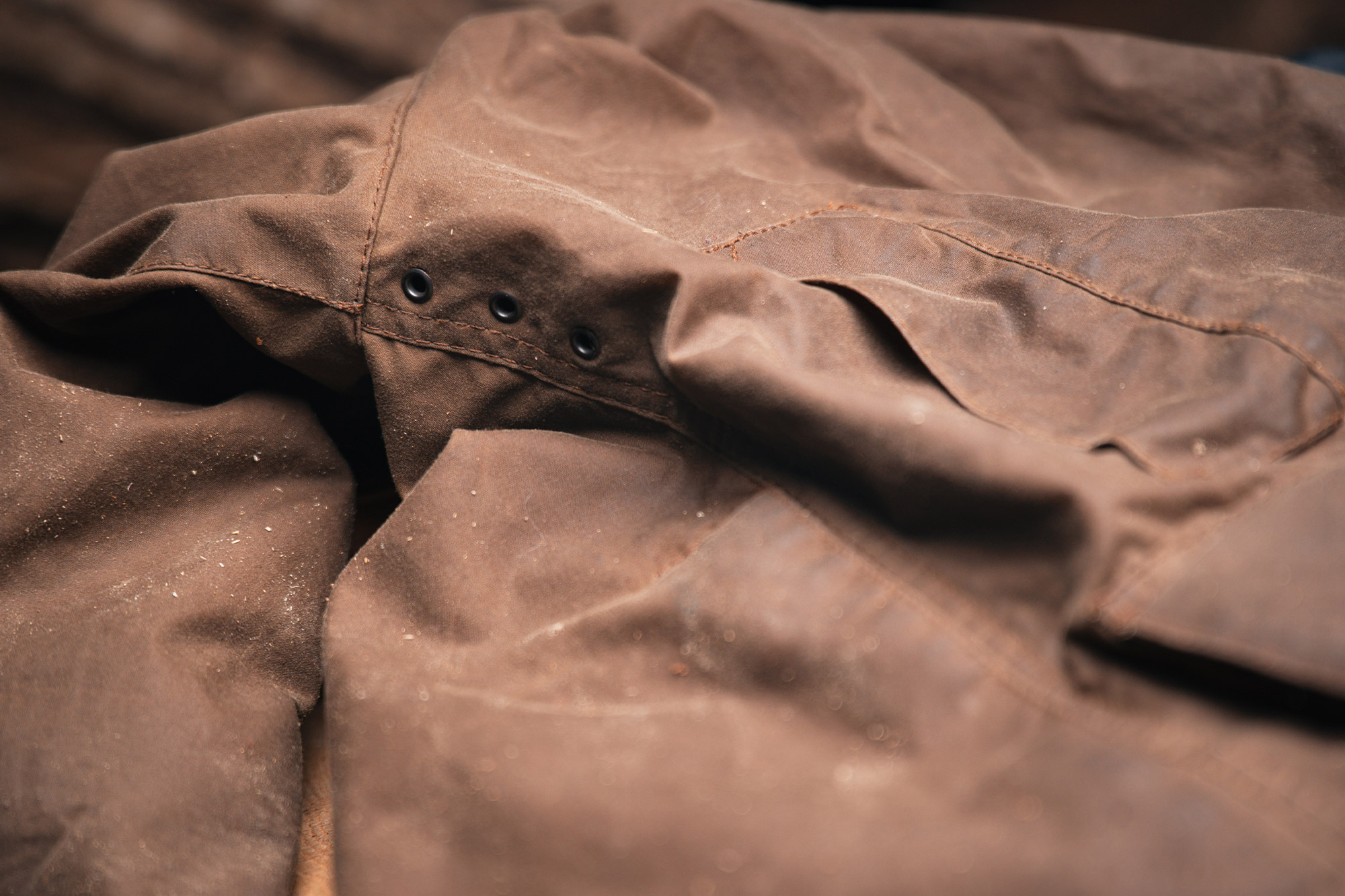 Detail of the Barbour Beaufort Wax Jacket showing underarm ventilation eyelets on the sleeve seam