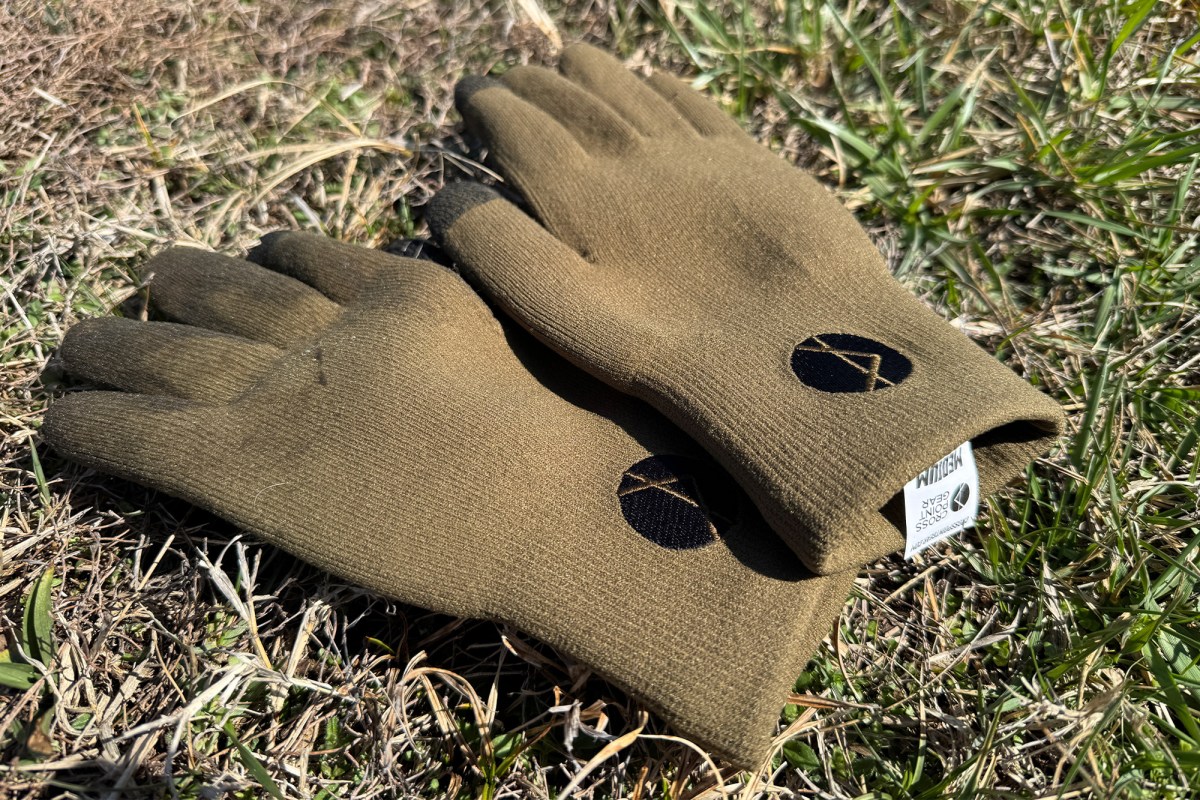 Pro wool gloves placed on grass showing full design