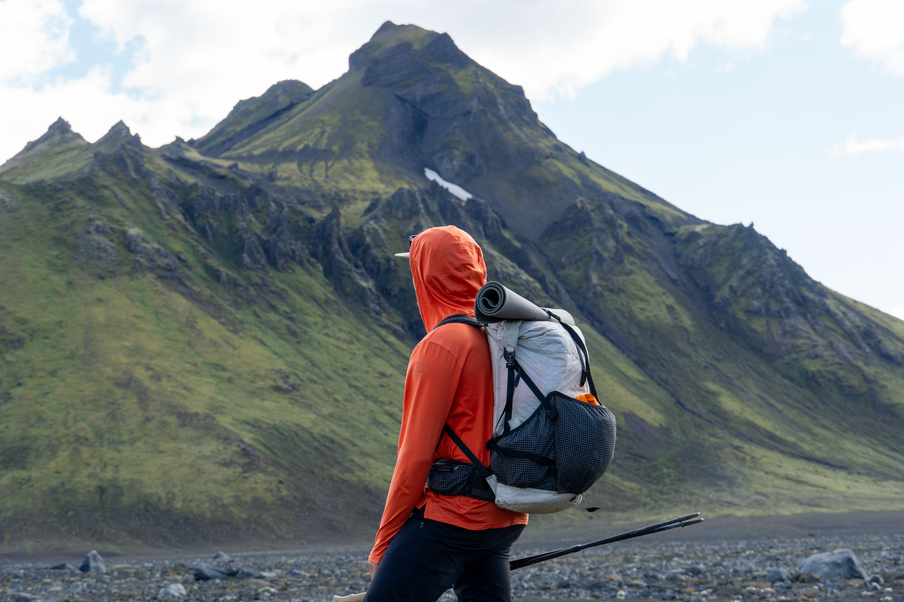 a gearjunkie tester hiking in iceland while wearing the ridge merino sun hoodie