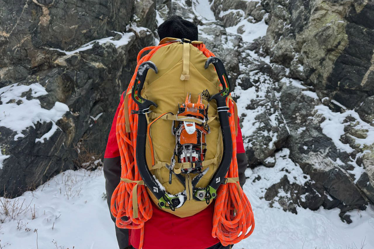 Ice tools secured to the front of the Gregory Alpinisto backpack with rope attached