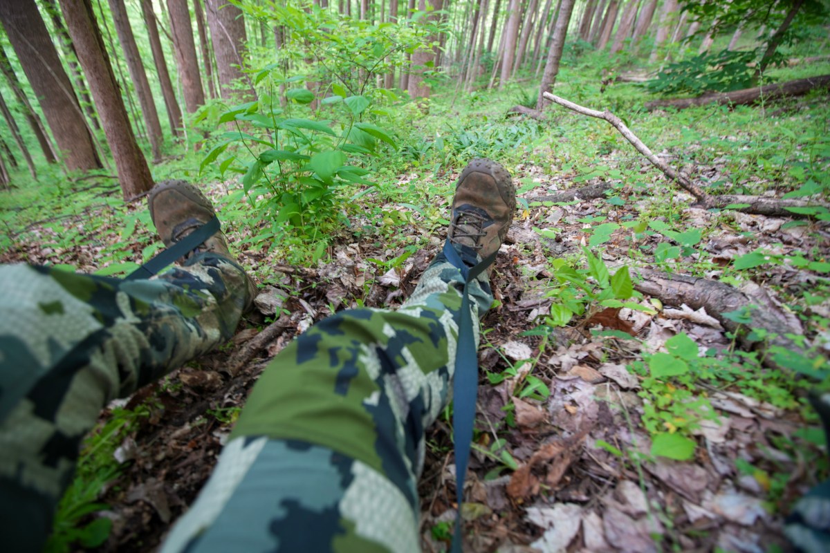A hunters feet in the LeanLock system on the KUIU Rival Turkey Vest