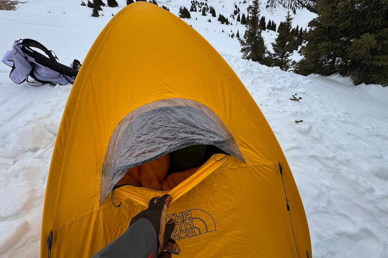 Front vent opening on yellow AMK tent with hand lifting flap