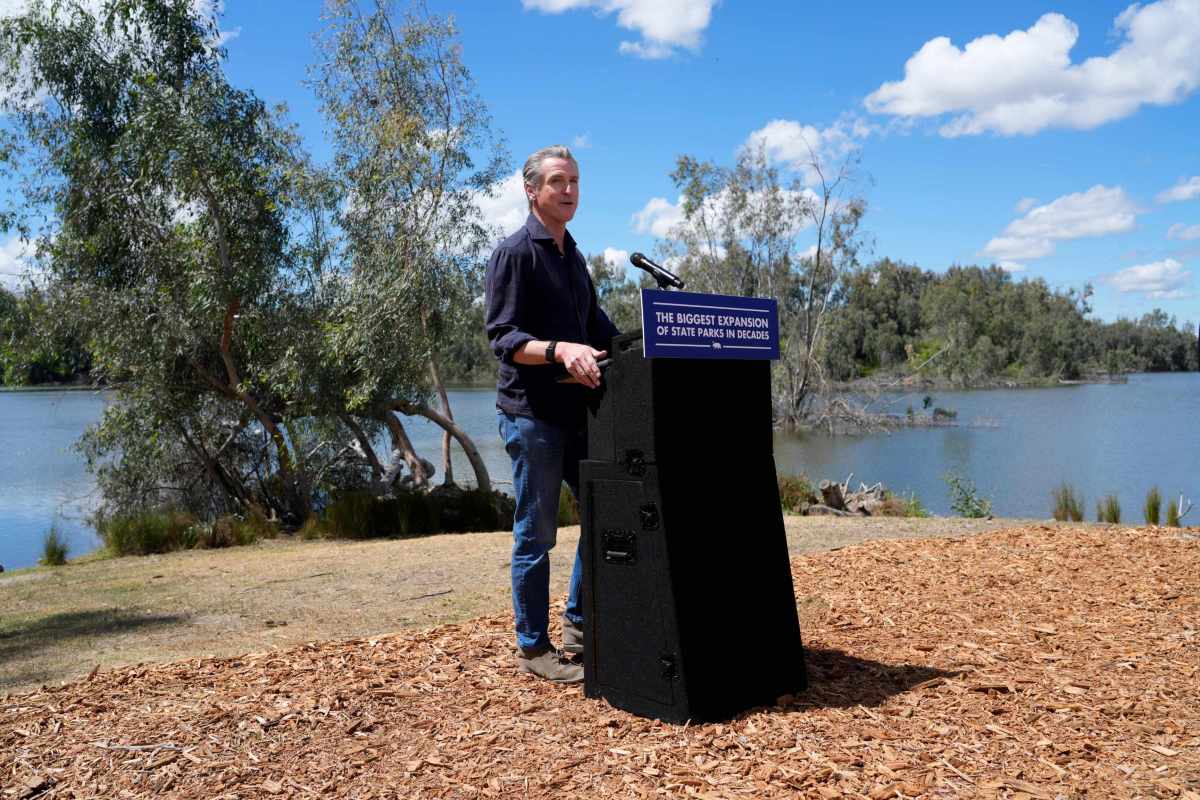 man stands at podium outside