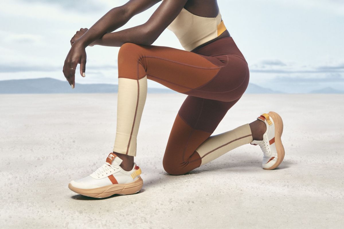 close-up shot of runner kneeling on sand