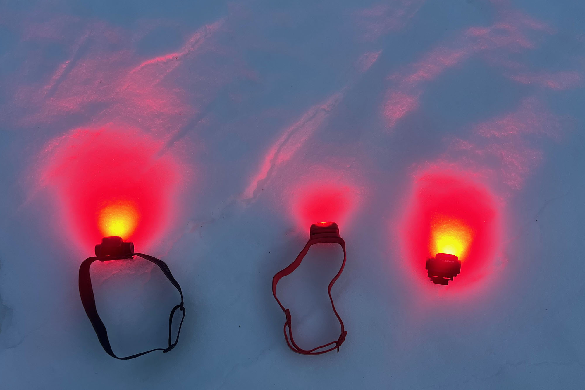 Fenix HM55R, left, Biolite Range 500, and Coast WPH10R in red mode