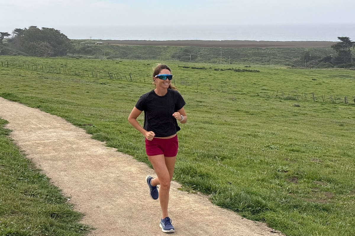 Runner wearing Oakley Meta AI glasses on a dirt path