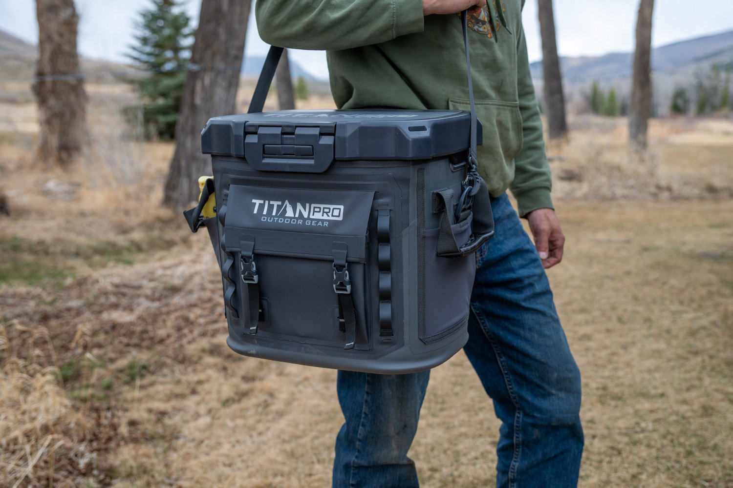 A person carrying the Titan PRO 36 Can cooler via the padded shoulder strap