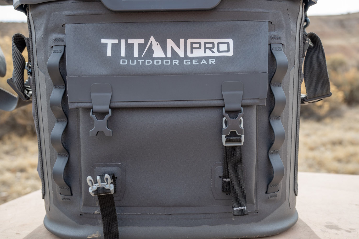 Close-up of Titan PRO outdoor cooler front panel showing buckle straps