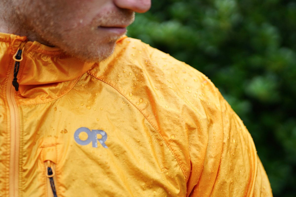 Man wears a wet windbreaker jacket