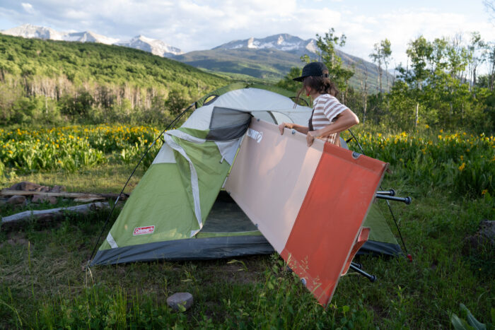 gearjunkie tester meghan lahatte sets up the klymit cedar mesa cot in a coleman tent in colorado during our testing 
