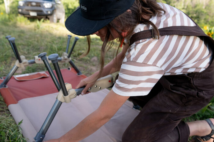 tester meghan lahatte assembles the legs of the klymit cedar mesa camping cot during testing